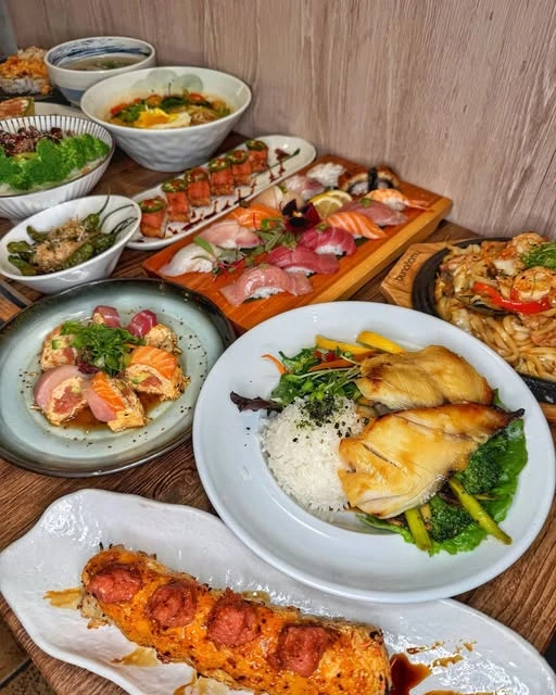 A Starfish table filled with nigiri, rolls, noodles and grilled fish